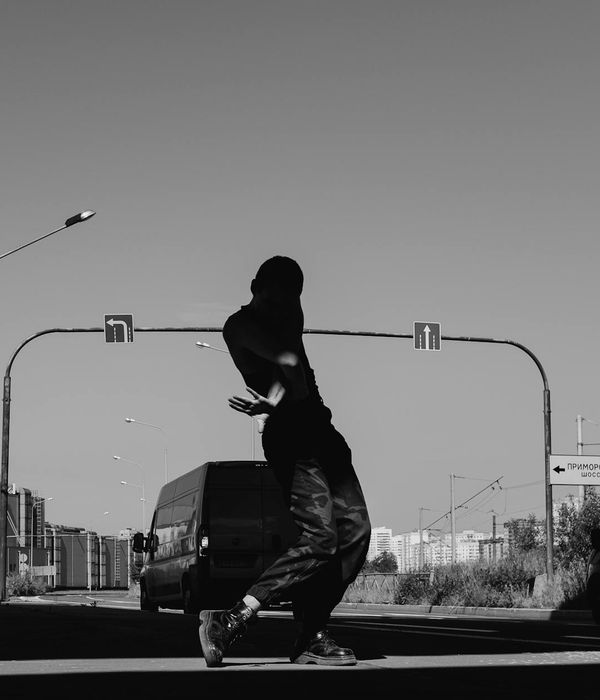 Silhouette of a man stretching against a sunrise, feeling energetic.